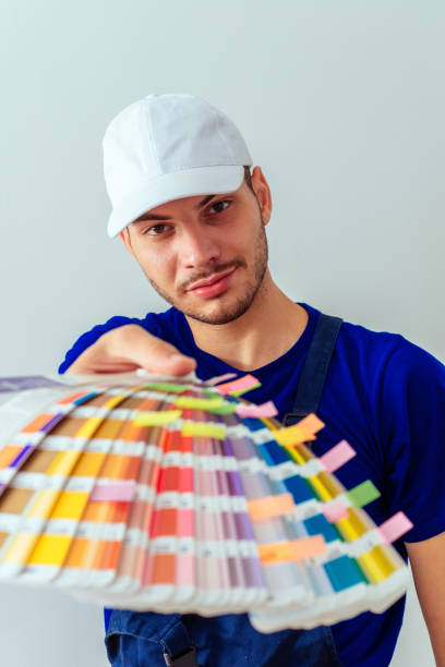 istock Positive guy holding color palette on white background 1386850421
