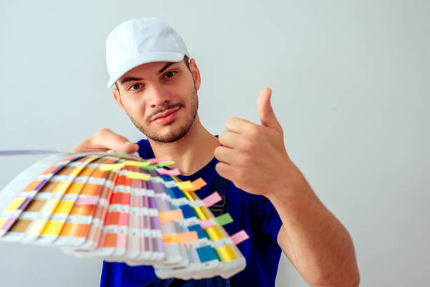 istock Positive guy holding color palette on white background 1386850424