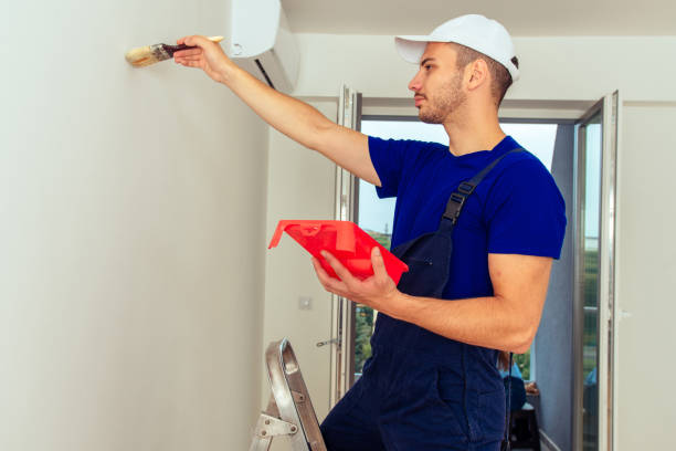 istock Young Man On Painting Wall With Paintbrush 1386850675