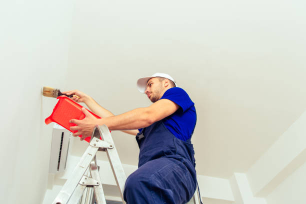 istock Craftsman renovate apartment on wall with paintbrush 1386850682