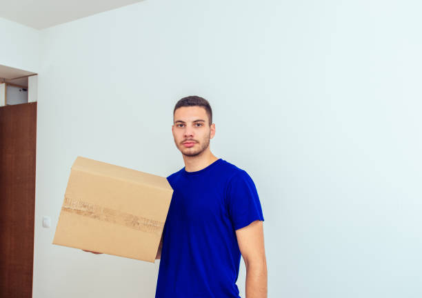 istock Handsome man holding cardboard box with items 1386850940