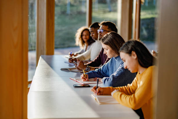 istock College students writing an exam on a class in the classroom. 1386851185