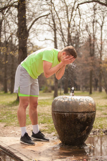 istock He is splashing and cleaning his face with water 1386852137