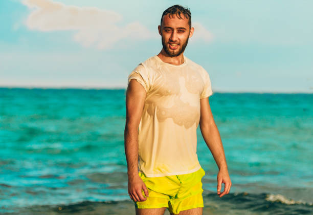 Portrait of handsome man enjoying holiday on the beach in the sea