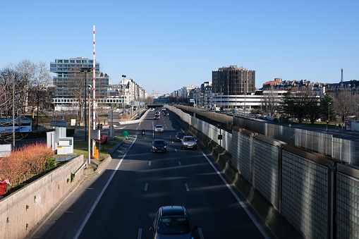 Paris, France - February 27, 2022 :  Cars using a highway near the financial district area of La Défense in Paris