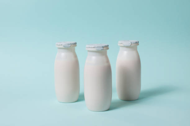 istock Bottles with probiotics and prebiotics dairy drink on light blue background. 1386852707