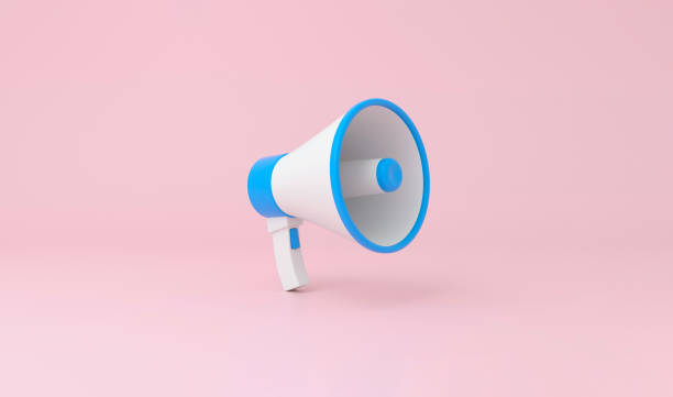 istock Megaphone in blue and white color on pastel pink background. 1386852911