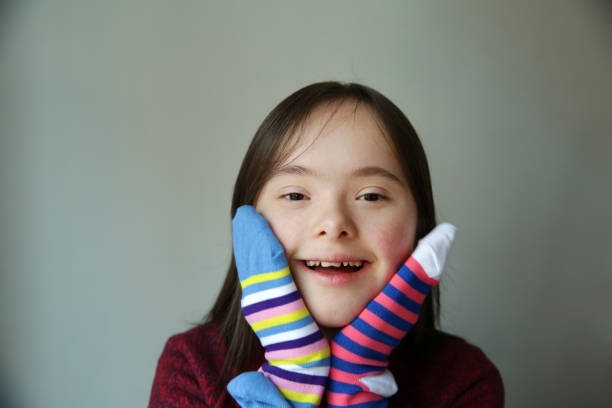 istock Beautiful girl smiling with different socks 1386853092