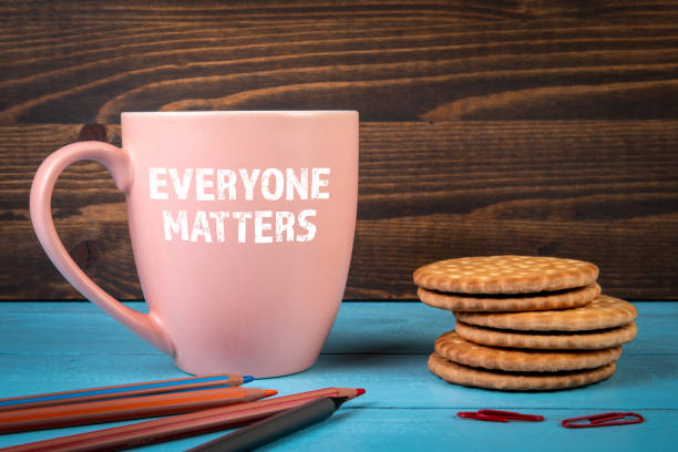 istock Everyone Matters. Coffee mug with text on the office desk 1386854267