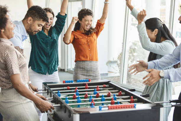 istock Colleagues playing table football 1386854395