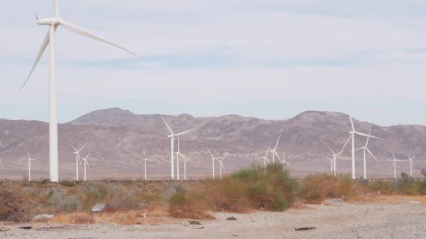 istock Windmills on wind farm, wind mill energy generators. Desert windfarm, USA. 1386855651