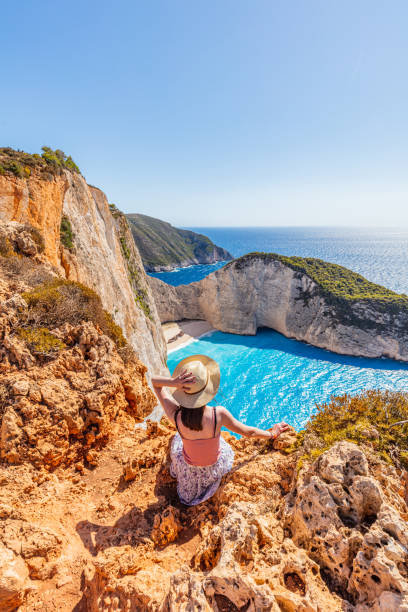 Woman tourist in Zakynthos, Greece admiring the Navagio beach stock photo