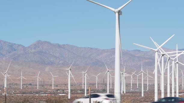 istock Windmills on wind farm, wind mill energy generators. Desert windfarm, USA. 1386857405