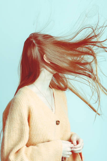 istock Wind blowing woman brown hair 1386857645