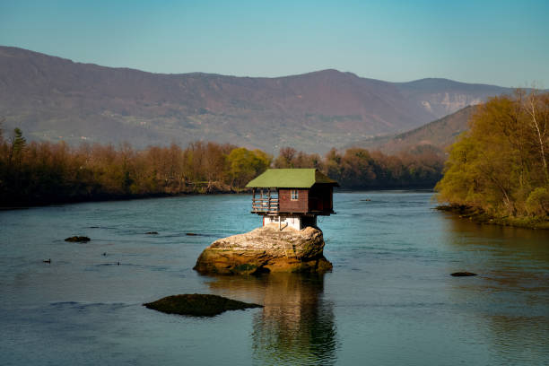 istock The tiny hut on the rock on river 1386857759