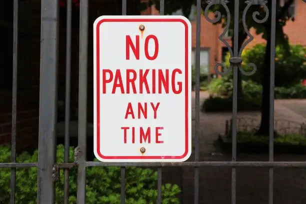 Photo of No parking sign on a gate