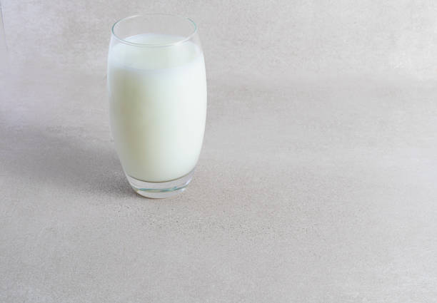 istock Glass of milk on light background 1386861066