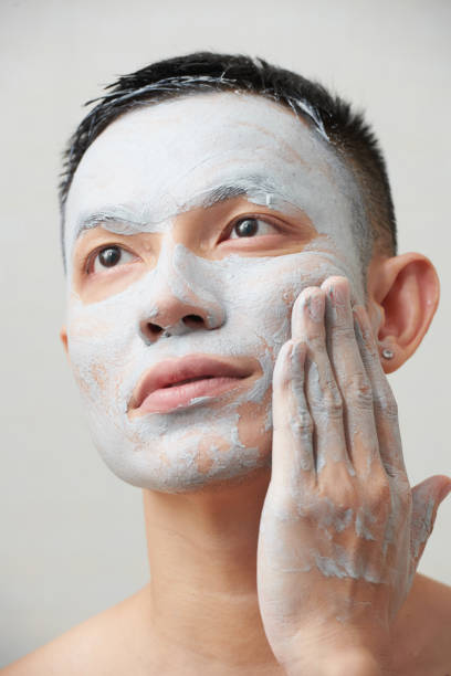 istock Man Wiping Off Clay Mask 1386861301