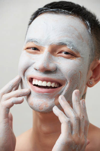 istock Man Applying Pore Tightening Clay Mask 1386861302