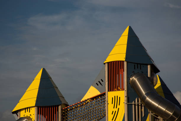 Detail of childs public play area structure against a blue sky at dusk
