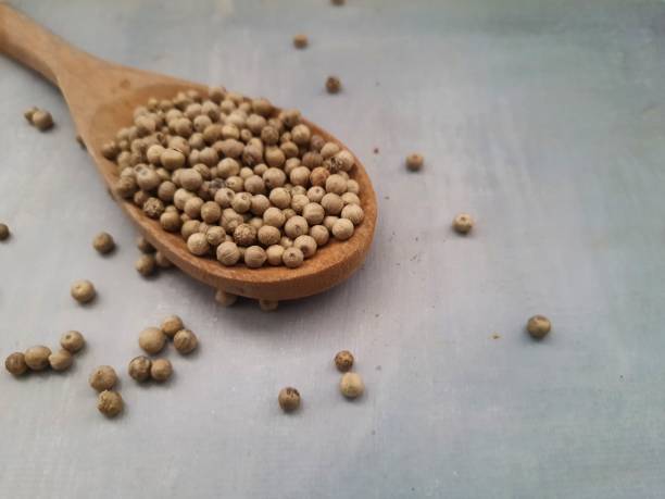 istock Wooden spoon with white pepper. 1386861466