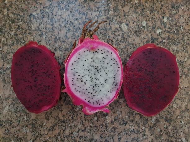 istock Dragon fruit or pitaya, red and white cut in half, isolated 1386861469