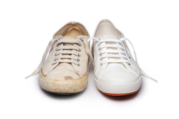 Old and new canvas tennis shoes stock photo