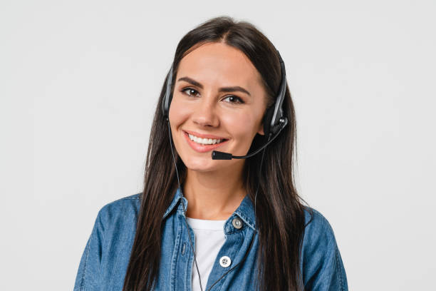 istock Smiling young caucasian hotline helpline worker, IT customer support manager in headset looking at camera assisting customer client isolated in white background 1386863830
