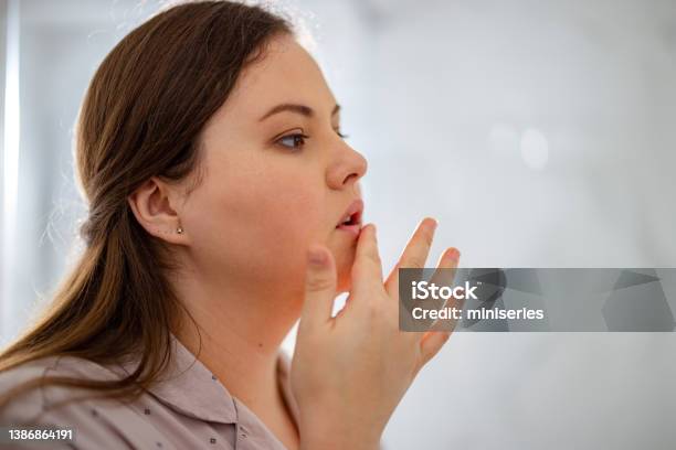 Portrait Of A Woman Touching Her Lip Stock Photo - Download Image Now - Human Lips, Dry, Pain
