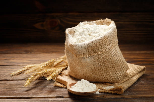 istock Flour in burlap bag on a wooden table. 1386864506
