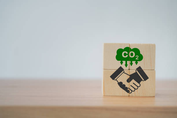 handshake icon on wooden cubes with CO2 emission reduction icon for  CO2 emission ,green industries business. Net zero emissions. renewable energy, sustainable technology, ecology solutions concept stock photo