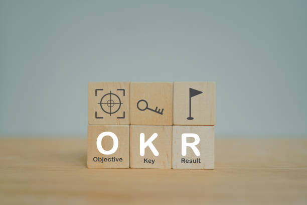 istock OKR white text (Objectives, Key and Results) on wooden cube blocks on table for  business target and focus concepts 1386866085