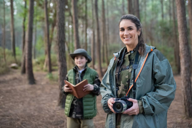istock Woman with camera in forest 1386866185