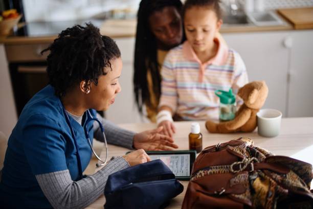 istock Mother and daughter answer doctor's questions 1386866370