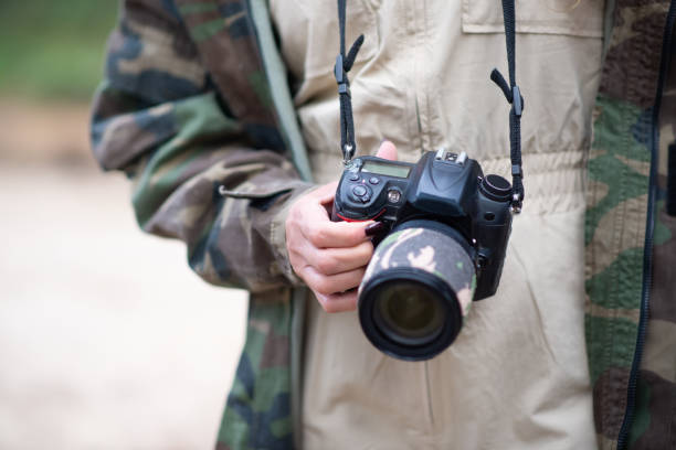 istock Close-up of modern photo camera in hands 1386866514