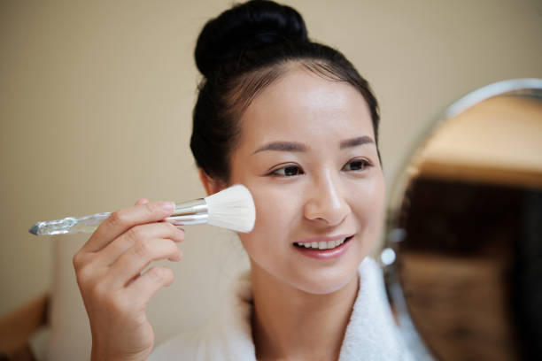 istock Woman Applying Liquid Foundation 1386869974