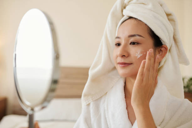 istock Woman Applying Anti-Aging Lotion 1386869993