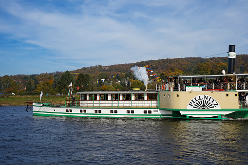 Dresden, Germany - October 31 2021: The paddle steamer 'Pillnitz' of the Sächsische Dampfschifffahrt on the river Elbe. Dresden has the oldest and largest paddle steamer fleet in the world.