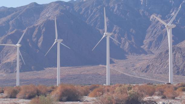istock Windmills on wind farm, wind mill energy generators. Desert windfarm, USA. 1386873786