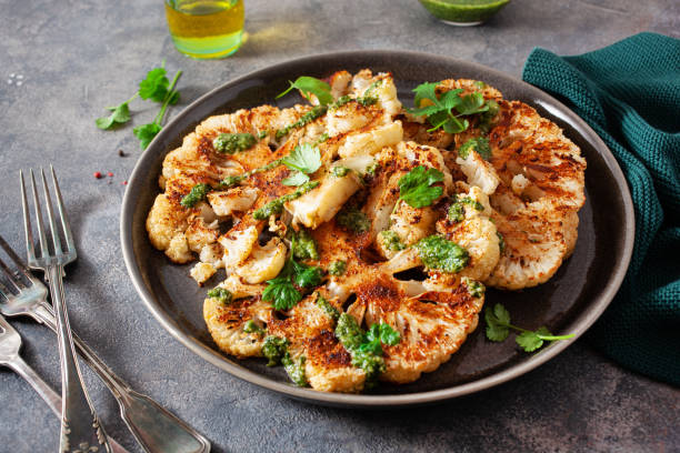 istock cauliflower steaks with herb sauce and spice. plant based meat substitute 1386878301