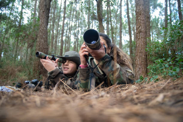 istock Focused mother and son taking pictures in forest 1386878431