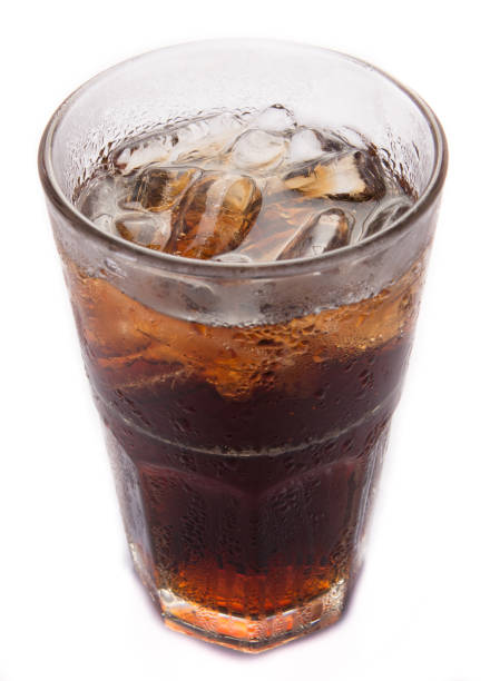 istock Glass of cola with ice on white background 1386879534