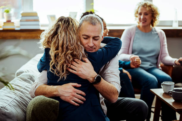 istock Husband and wife hugging each other during a marriage counseling session 1386881210