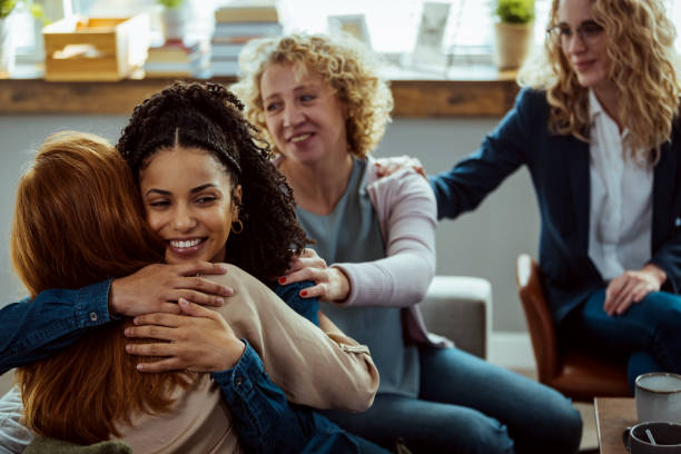 istock Two people are embracing each other and other members are supporting them. 1386881228