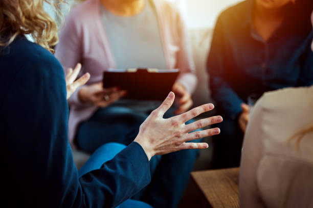 istock Emotional woman sharing her story during support session 1386881254