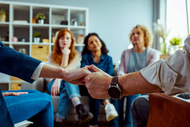 istock Close-up of people attending group therapy. 1386881595
