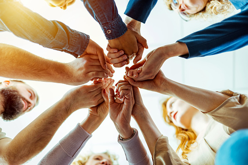 Startup company employee team stacking hand together symbolize successful group of business partnership and strong collective unity teamwork in community workplace in panoramic banner. Synergic