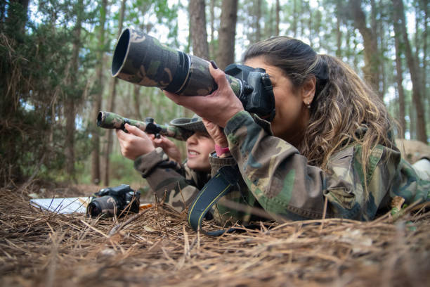 istock Absorbed mother and son taking pictures in forest 1386881841