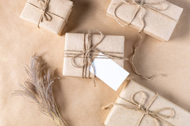 istock empty white gift tag mock up on craft paper box with dried spikelets decoration on natural beige background. 1386884062
