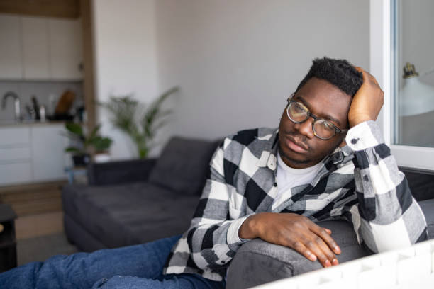 istock Young African American man feeling sick at home 1386885328